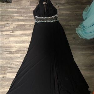 Black floor length formal dress with sheer rhinestoned midsection and open back